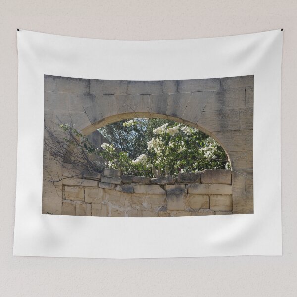 Item preview, Stone Arch Window With White Bougainvillea Blossoms Over Sunlit Mediterranean Ruin Wall designed and sold by Nmallia.