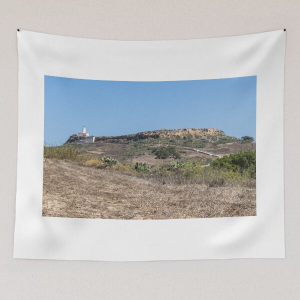 Item preview, White Lighthouse on Arid Coastal Hill Overlooking Dry Landscape and Blue Sky designed and sold by Nmallia.
