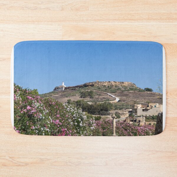 Item preview, White Lighthouse on Rocky Hill Overlooking Village and Pink Oleander Flowers Under Clear Blue Sky designed and sold by Nmallia.