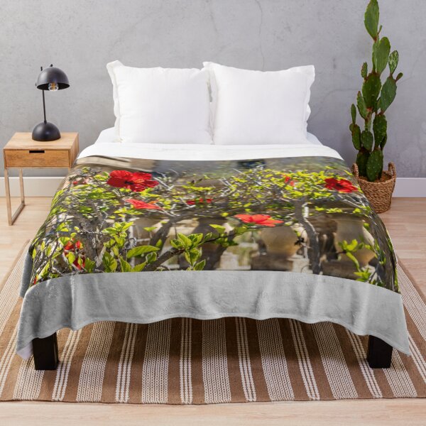 Item preview, Red Hibiscus Flowers Blooming On A Garden Hedge With Stone Balustrade In Sunny Light designed and sold by Nmallia.