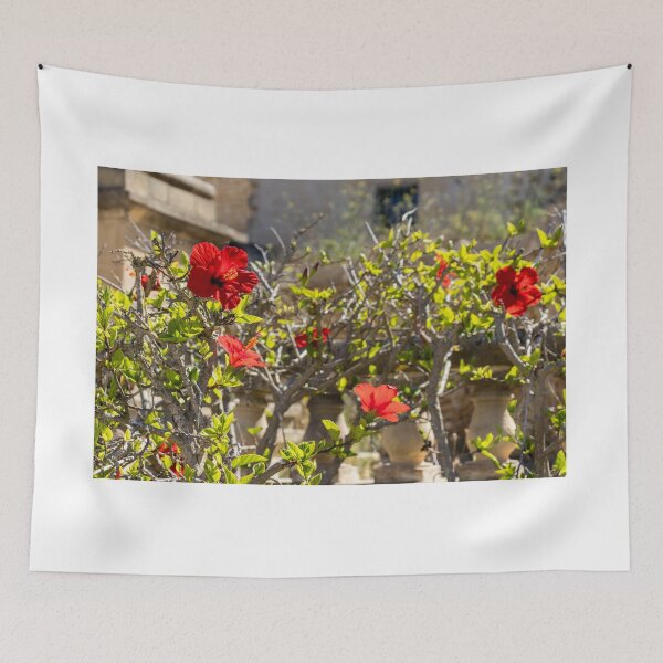 Item preview, Red Hibiscus Flowers Blooming On A Garden Hedge With Stone Balustrade In Sunny Light designed and sold by Nmallia.