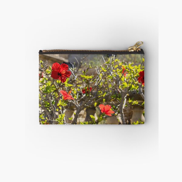 Item preview, Red Hibiscus Flowers Blooming On A Garden Hedge With Stone Balustrade In Sunny Light designed and sold by Nmallia.