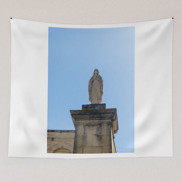 Item preview, Stone Marian Statue On Tall Column In Sunny Mediterranean Village With Historic Buildings designed and sold by Nmallia.