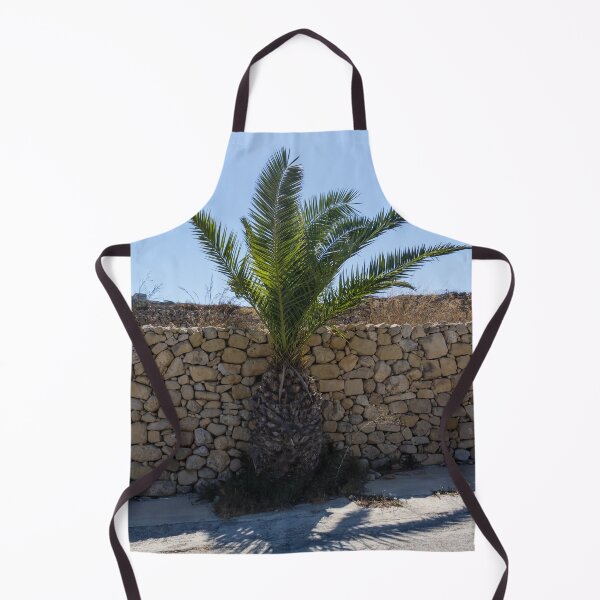 Item preview, Young Palm Tree Growing Against Rustic Stone Wall Under Bright Blue Sky With Sunlit Shadow designed and sold by Nmallia.