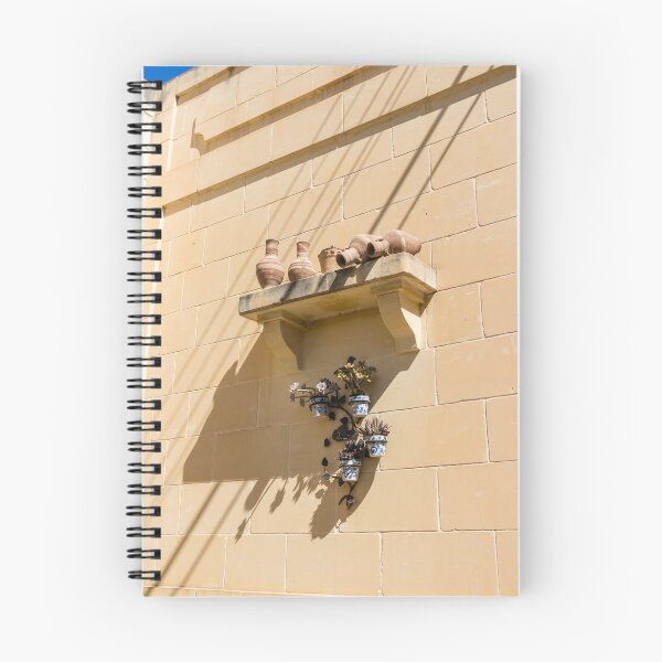 Item preview, Terracotta Pots And Blue Ceramic Planters On Sunlit Sandstone Wall With Deep Shadows designed and sold by Nmallia.