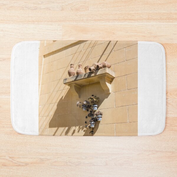 Item preview, Terracotta Pots And Blue Ceramic Planters On Sunlit Sandstone Wall With Deep Shadows designed and sold by Nmallia.