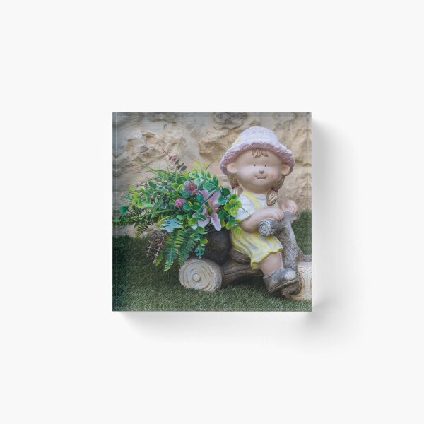 Item preview, Whimsical Garden Figurine Of Girl On Wooden Tricycle With Flowers Against Stone Wall designed and sold by Nmallia.