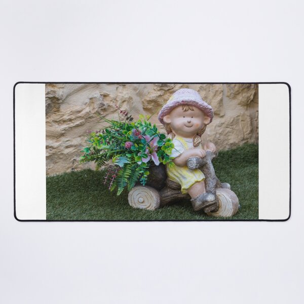 Item preview, Whimsical Garden Figurine Of Girl On Wooden Tricycle With Flowers Against Stone Wall designed and sold by Nmallia.