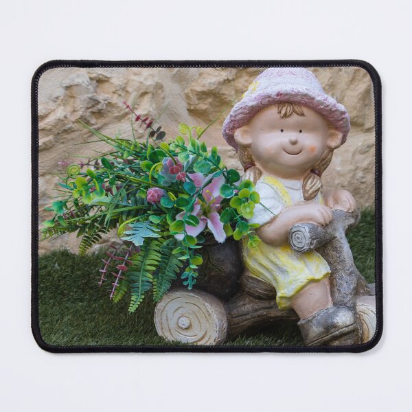 Item preview, Whimsical Garden Figurine Of Girl On Wooden Tricycle With Flowers Against Stone Wall designed and sold by Nmallia.