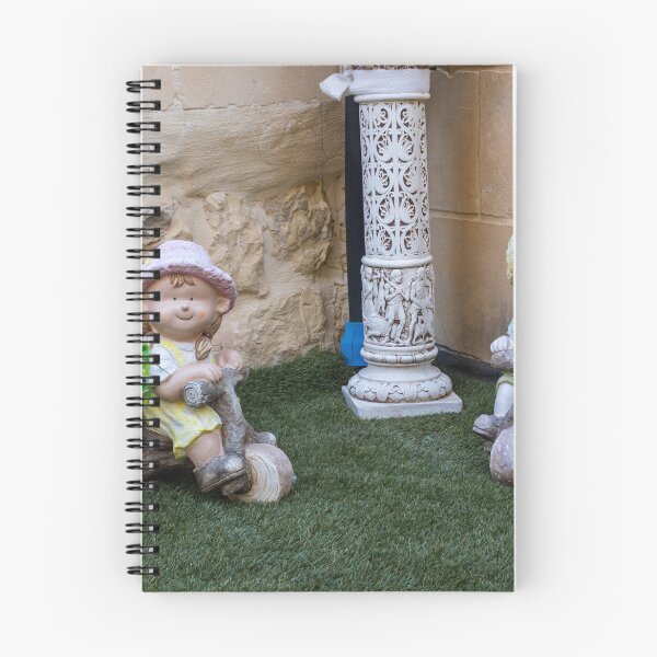Item preview, Whimsical Garden Figurine Of Girl On Wooden Tricycle With Flowers Against Stone Wall designed and sold by Nmallia.
