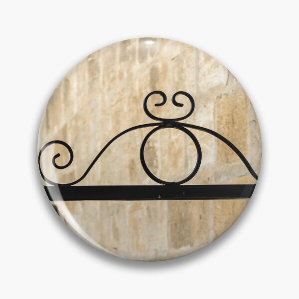 Item preview, Wrought Iron Decorative Gate Bracket With Scrollwork Against Sunlit Stone Wall in Historic Courtyard designed and sold by Nmallia.