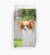 Portrait of a papillon purebreed dog with grass behind Duvet Cover