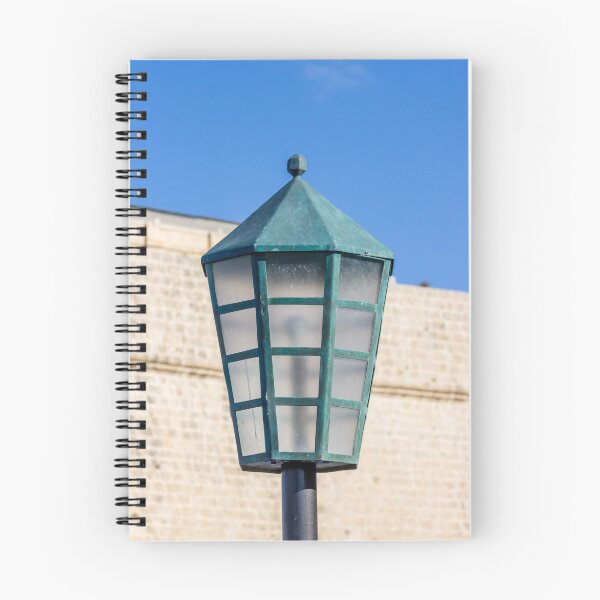 Item preview, Vintage Green Street Lamp Lantern Against Blue Sky and Stone Wall Architectural Detail designed and sold by Nmallia.
