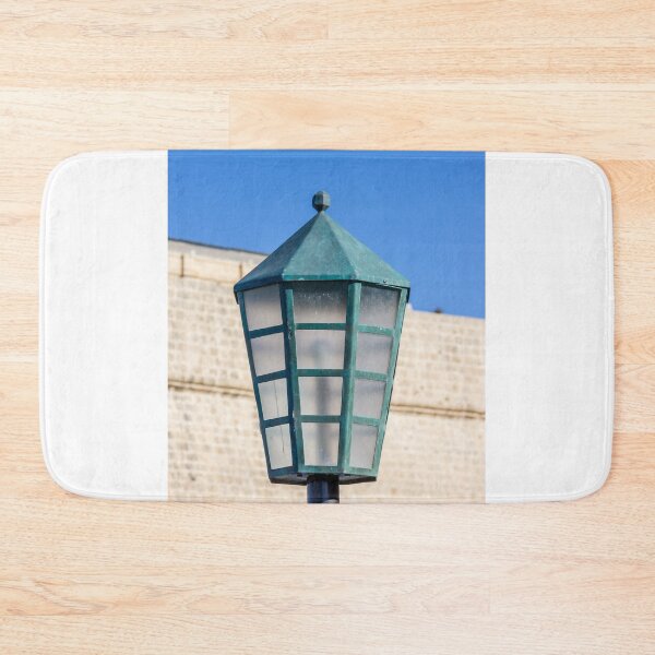 Item preview, Vintage Green Street Lamp Lantern Against Blue Sky and Stone Wall Architectural Detail designed and sold by Nmallia.