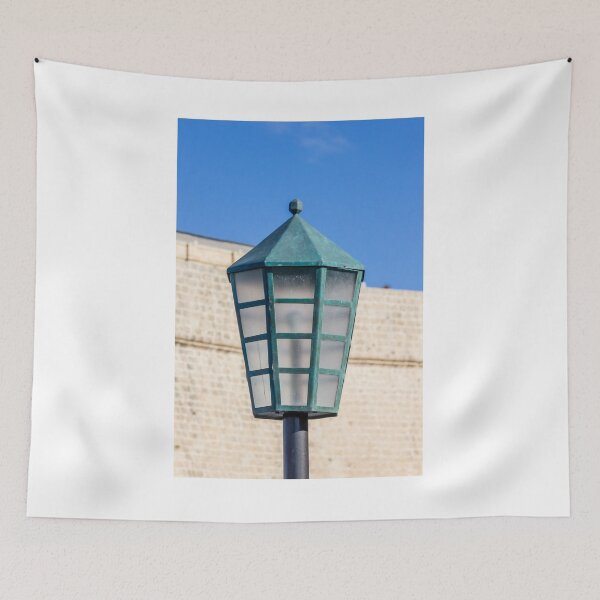 Item preview, Vintage Green Street Lamp Lantern Against Blue Sky and Stone Wall Architectural Detail designed and sold by Nmallia.