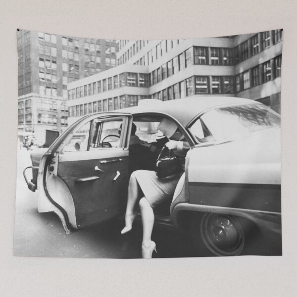 Item preview, Fashionable woman exiting a yellow cab taxi in New York City vintage black and white art print photograph designed and sold by Astrid Arkhangelsky.