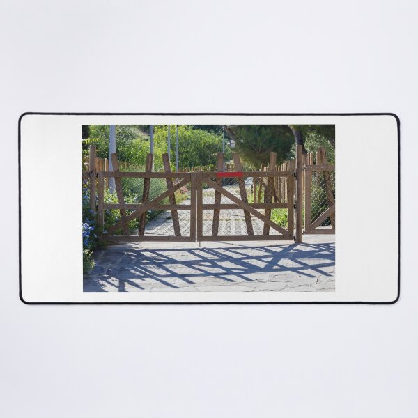 Item preview, Rustic Wooden Gate And Garden Fence Opening Onto Sunlit Path With Strong Shadow Patterns designed and sold by Nmallia.