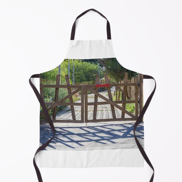 Item preview, Rustic Wooden Gate And Garden Fence Opening Onto Sunlit Path With Strong Shadow Patterns designed and sold by Nmallia.