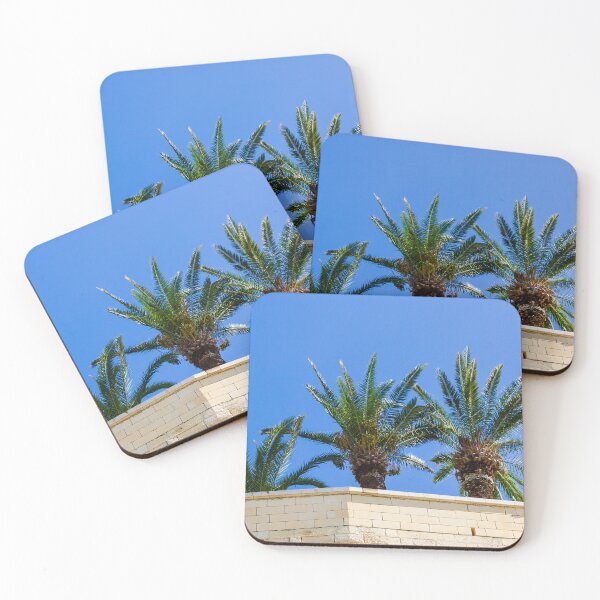 Item preview, Three Palm Trees Rising Above A Pale Stone Wall Under A Clear Blue Sky On A Sunny Day designed and sold by Nmallia.
