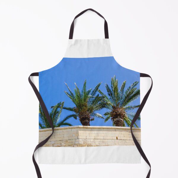 Item preview, Three Palm Trees Rising Above A Pale Stone Wall Under A Clear Blue Sky On A Sunny Day designed and sold by Nmallia.