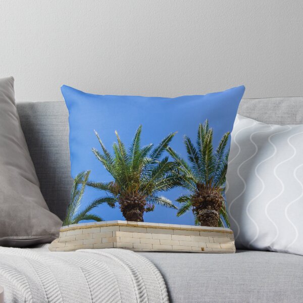 Item preview, Three Palm Trees Rising Above A Pale Stone Wall Under A Clear Blue Sky On A Sunny Day designed and sold by Nmallia.