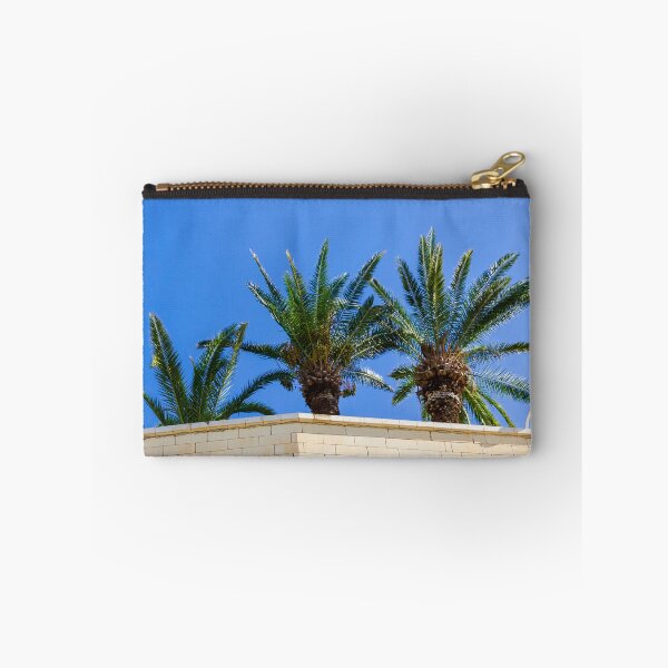 Item preview, Three Palm Trees Rising Above A Pale Stone Wall Under A Clear Blue Sky On A Sunny Day designed and sold by Nmallia.