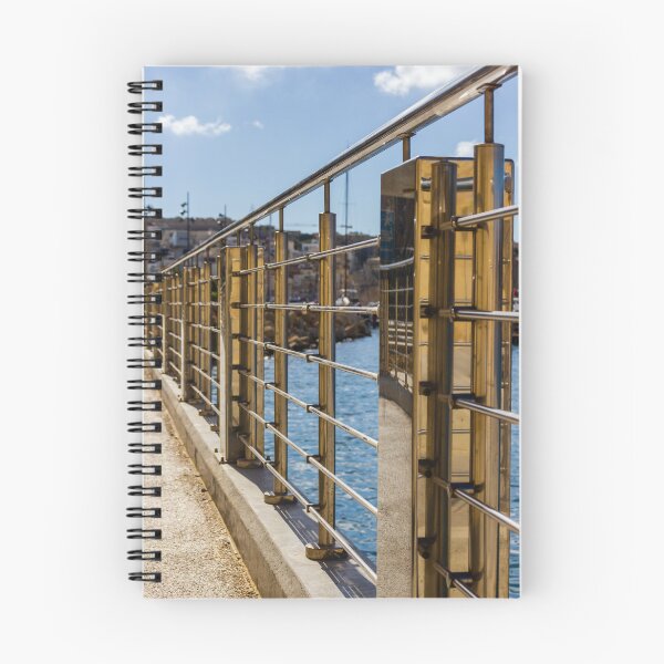 Item preview, Stainless Steel Railing Along Marina Waterfront Promenade With Blue Sea Reflections And Sunny Walkway designed and sold by Nmallia.