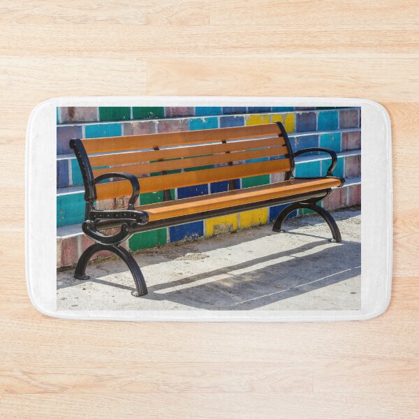 Item preview, Empty Wooden Bench Against Colorful Tiled Steps in Sunny Outdoor Urban Park designed and sold by Nmallia.