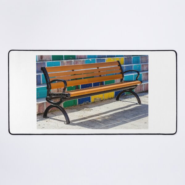 Item preview, Empty Wooden Bench Against Colorful Tiled Steps in Sunny Outdoor Urban Park designed and sold by Nmallia.