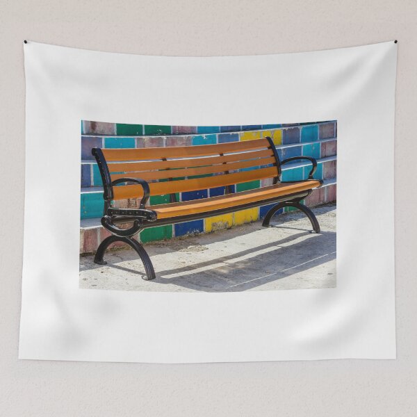 Item preview, Empty Wooden Bench Against Colorful Tiled Steps in Sunny Outdoor Urban Park designed and sold by Nmallia.