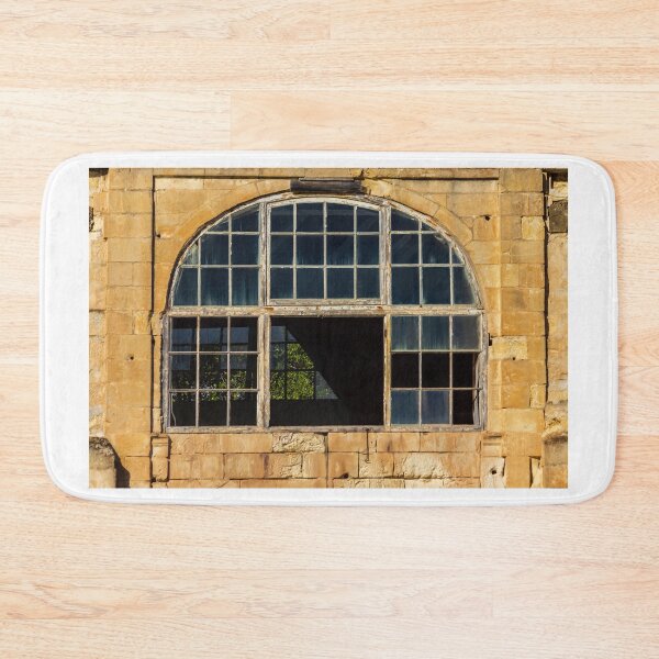 Item preview, Arched Old Window With Broken Panes in Weathered Stone Wall of Abandoned Building designed and sold by Nmallia.