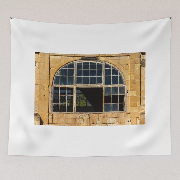 Item preview, Arched Old Window With Broken Panes in Weathered Stone Wall of Abandoned Building designed and sold by Nmallia.