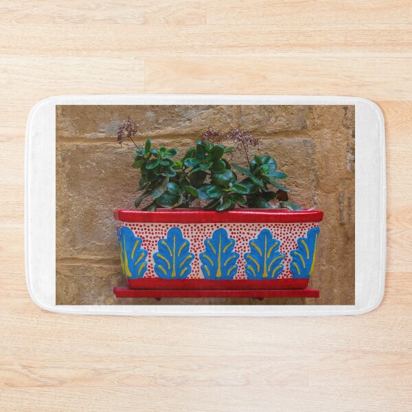Item preview, Colorful Painted Planter With Green Succulent Against A Textured Stone Wall designed and sold by Nmallia.