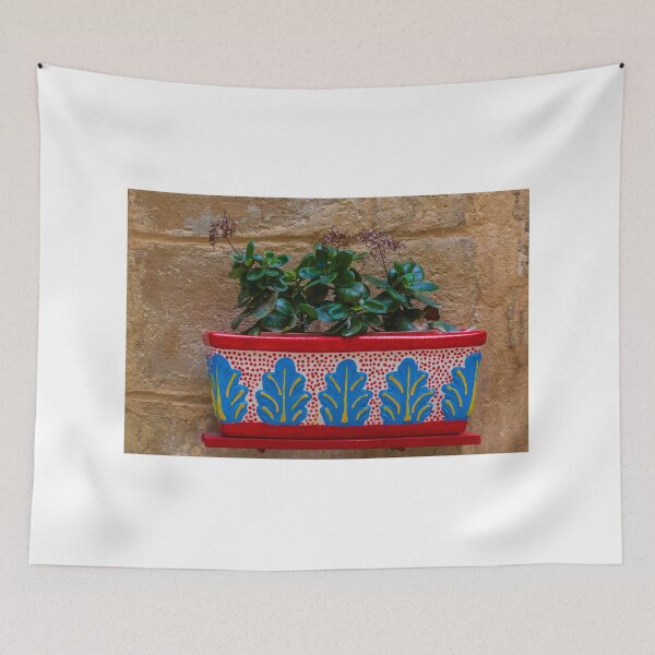Item preview, Colorful Painted Planter With Green Succulent Against A Textured Stone Wall designed and sold by Nmallia.