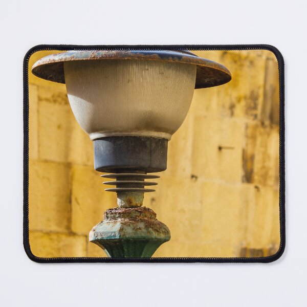 Item preview, Vintage Rusted Street Lamp Post Against Sunlit Yellow Stone Wall, Urban Texture and Decay designed and sold by Nmallia.