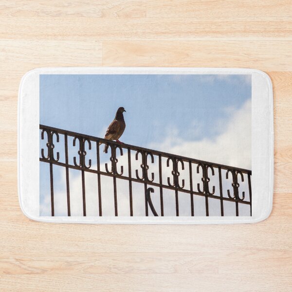 Item preview, Pigeon Perched on Ornate Metal Fence Against Blue Sky — Urban Bird Silhouette on Railing designed and sold by Nmallia.