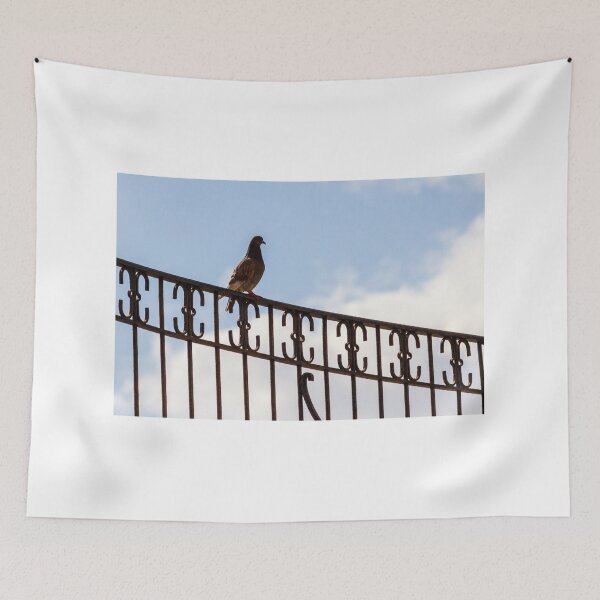 Item preview, Pigeon Perched on Ornate Metal Fence Against Blue Sky — Urban Bird Silhouette on Railing designed and sold by Nmallia.