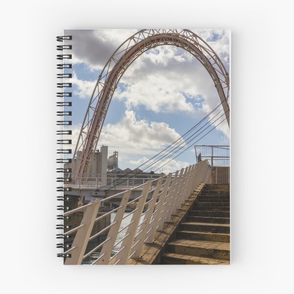 Item preview, Modern Arch Bridge With Stairs and Railing Over Harbor Water Under Dramatic Cloudy Sky designed and sold by Nmallia.