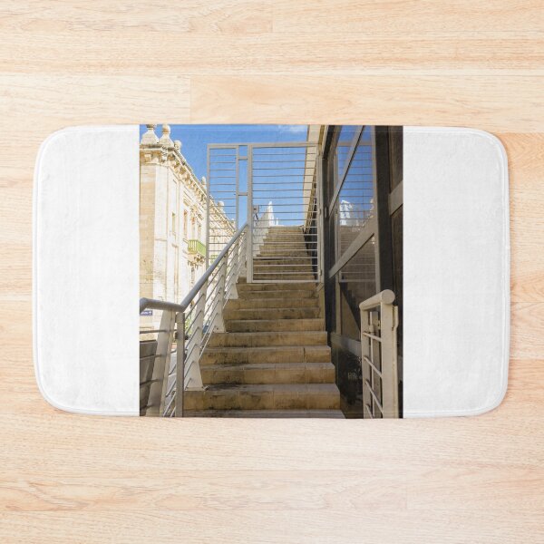 Item preview, Sunlit Stone Stairs and White Metal Gate Leading Up Between Modern Glass and Historic Architecture designed and sold by Nmallia.