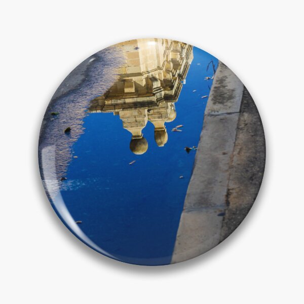 Item preview, Architectural Reflection in Puddle on Urban Street With Blue Sky and Historic Building Details designed and sold by Nmallia.