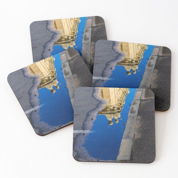 Item preview, Architectural Reflection in Puddle on Urban Street With Blue Sky and Historic Building Details designed and sold by Nmallia.