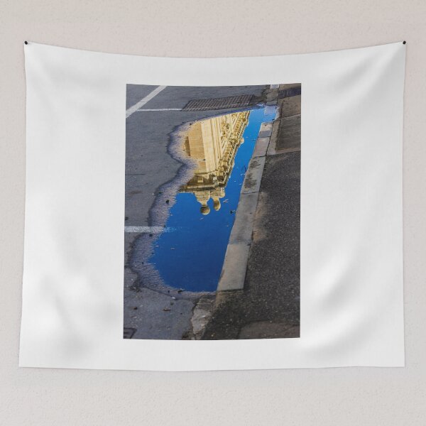 Item preview, Architectural Reflection in Puddle on Urban Street With Blue Sky and Historic Building Details designed and sold by Nmallia.