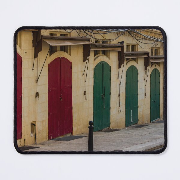 Item preview, Row Of Colorful Arched Wooden Doors On Stone Building Facade With Weathered Awnings designed and sold by Nmallia.