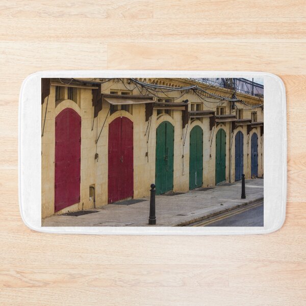 Item preview, Row Of Colorful Arched Wooden Doors On Stone Building Facade With Weathered Awnings designed and sold by Nmallia.