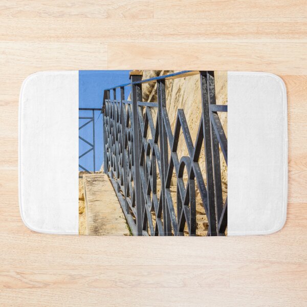 Item preview, Wrought Iron Railing on Stone Staircase With Geometric Pattern Against Blue Sky designed and sold by Nmallia.