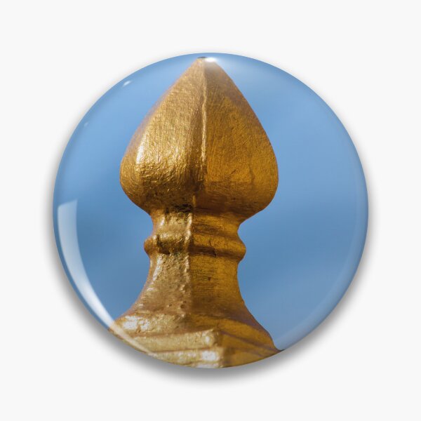 Item preview, Golden Finial Fence Post Close-Up Against Blue Sky – Gilded Decorative Metal Railing Detail designed and sold by Nmallia.