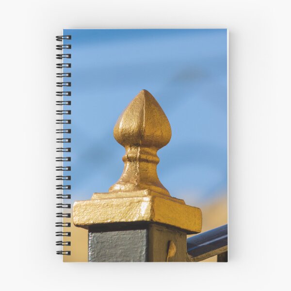 Item preview, Golden Finial Fence Post Close-Up Against Blue Sky – Gilded Decorative Metal Railing Detail designed and sold by Nmallia.