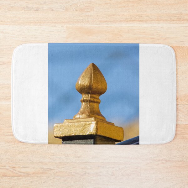Item preview, Golden Finial Fence Post Close-Up Against Blue Sky – Gilded Decorative Metal Railing Detail designed and sold by Nmallia.