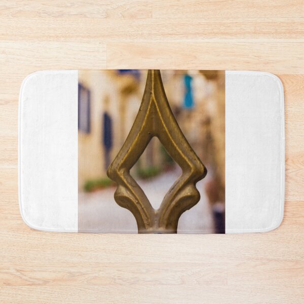 Item preview, Brass Finial Close-Up on Ornate Fence With Shallow Street Bokeh and Warm Mediterranean Tones designed and sold by Nmallia.