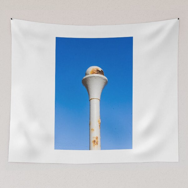 Item preview, Weathered White Metal Post With Rusty Ball Finial Against Clear Blue Sky, Close-Up Architectural Detail designed and sold by Nmallia.